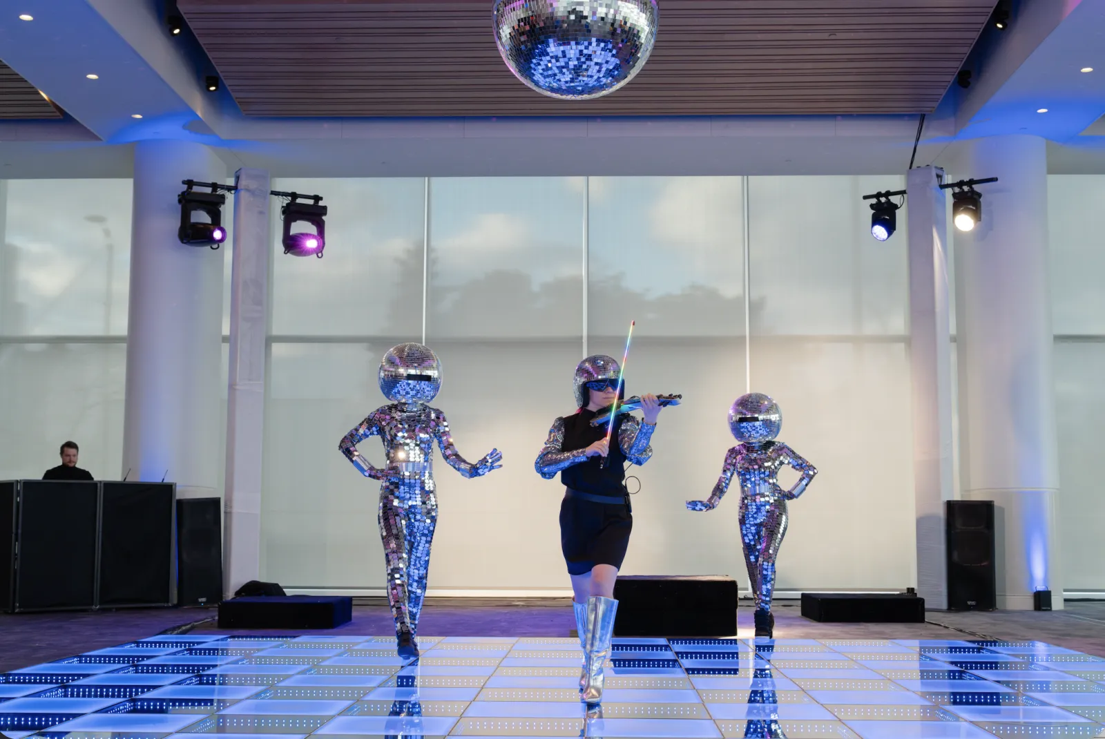 Ashley at Mirror Ball at Discovery World, flanked by mirror-ball performers