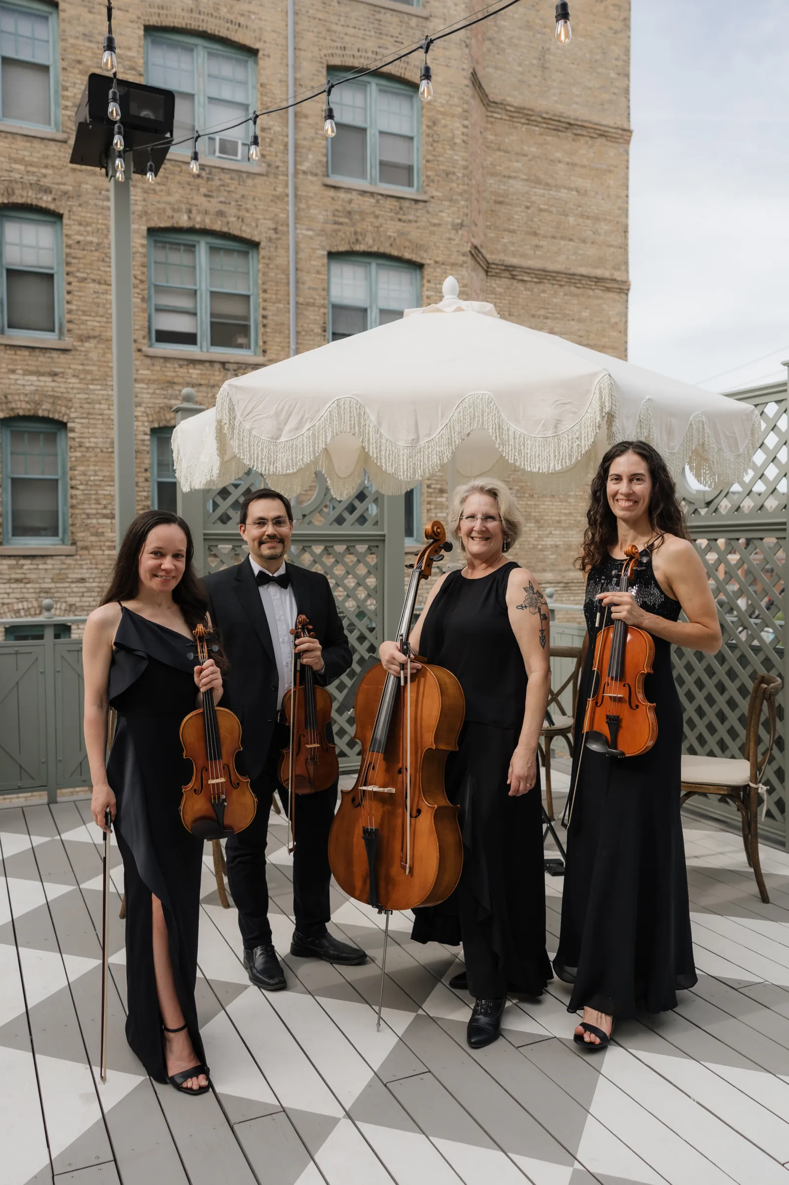 A string quartet performing on a rooftop terrace